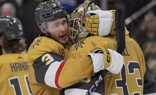 Vegas Golden Knights defenseman Brayden McNabb (3) embraces Vegas Golden Knights goaltender Adin Hill (33) after defeating the Dallas Stars in Game 6 of an NHL hockey Stanley Cup first-round playoff series Friday, May 3, 2024, in Las Vegas. (AP Photo/John Locher)
