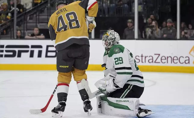 Dallas Stars goaltender Jake Oettinger (29) blocks a shot by the Vegas Golden Knights during the second period in Game 6 of an NHL hockey Stanley Cup first-round playoff series Friday, May 3, 2024, in Las Vegas. (AP Photo/John Locher)