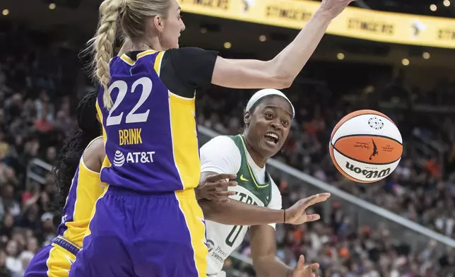 Los Angeles Sparks' Cameron Brink (22) tries to block the pass from Seattle Storm's Kaela Davis (0) during the first half of a WNBA preseason basketball game in Edmonton, Alberta, on Saturday, May 4, 2024. (Jason Franson/The Canadian Press via AP)