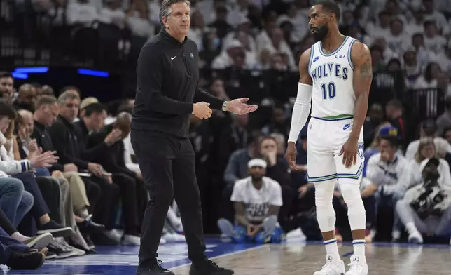 Minnesota Timberwolves head coach Chris Finch and guard Mike Conley (10) talk during the second half of Game 2 of an NBA basketball first-round playoff series against the Phoenix Suns, Tuesday, April 23, 2024, in Minneapolis. (AP Photo/Abbie Parr)