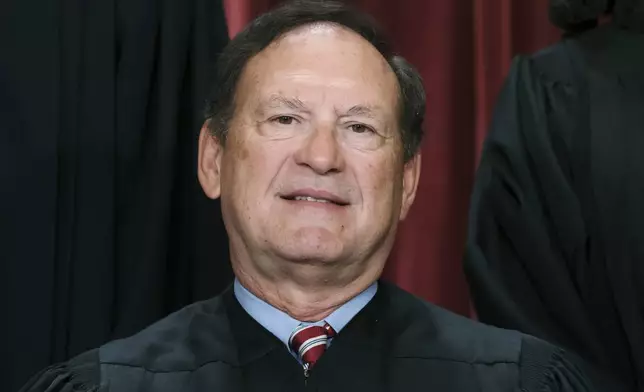 FILE - Associate Justice Samuel Alito joins other members of the Supreme Court as they pose for a new group portrait, Oct. 7, 2022, at the Supreme Court building in Washington. Alito rejects calls to step aside from Supreme Court cases on Trump and Jan. 6. (AP Photo/J. Scott Applewhite, File)