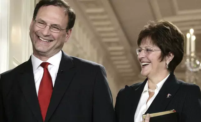 FILE - Supreme Court Justice Samuel Alito, left, and Martha-Ann Alito attend his ceremonial swearing-in at the White House Feb. 1, 2006, in Washington. An upside-down American flag was displayed outside of Alito's home Jan. 17, 2021, days after former President Donald Trump supporters stormed the U.S. Capitol, The New York Times reports. It's a symbol associated with Trump's false claims of election fraud. "It was briefly placed by Mrs. Alito in response to a neighbor's use of objectionable and personally insulting language on yard signs," Alito said in an emailed statement to the newspaper. (AP Photo/Charles Dharapak, File)