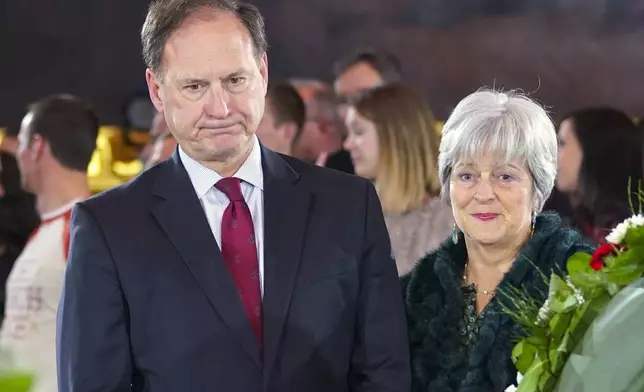 FILE - Supreme Court Justice Samuel Alito Jr., left, and his wife Martha-Ann Alito, pay their respects at the casket of Reverend Billy Graham at the Rotunda of the U.S. Capitol Building in Washington, Feb. 28, 2018. Alito rejects calls to step aside from Supreme Court cases on Trump and Jan. 6. (AP Photo/Pablo Martinez Monsivais, File)