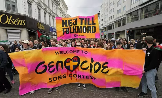 Protesters hold up a banner with the words in Swedish "No To Genocide" during a Pro-Palestinian demonstration for excluding Israel from Eurovision ahead of the second semi-final at the Eurovision Song Contest in Malmo, Sweden, Thursday, May 9, 2024. (AP Photo/Martin Meissner)