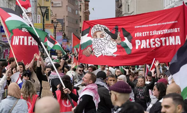 People carry a banner with the words in Swedish "For an independent Palestine" during a Pro-Palestinian demonstration for excluding Israel from Eurovision ahead of the second semi-final at the Eurovision Song Contest in Malmo, Sweden, Thursday, May 9, 2024. (AP Photo/Martin Meissner)