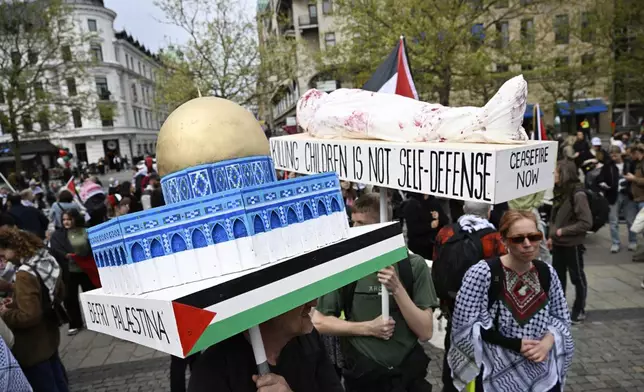 Protestors carry a model of the Dome of the Rock during a Stop Israel demonstration, between Stortorget and Mölleplatsen in Malmö, Sweden, Thursday, May 9, 2024. There have been calls for Israel to be excluded from the Eurovision Song contest because of its conduct in its war against Hamas. (Johan Nilsson/TT News Agency via AP)