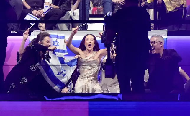 Eden Golan of Israel, centre, celebrates gaining a place in the final during the second semi-final at the Eurovision Song Contest in Malmo, Sweden, Thursday, May 9, 2024. (AP Photo/Martin Meissner)