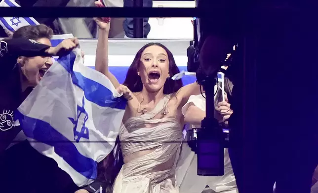 Eden Golan of Israel, bottom centre, celebrates gaining a place in the final during the second semi-final at the Eurovision Song Contest in Malmo, Sweden, Thursday, May 9, 2024. (AP Photo/Martin Meissner)
