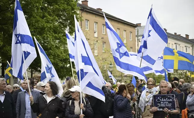 People carry Israeli and Swedish flags during a pro-Israel demonstration to pay tribute to Israel's Eurovision participant Eden Golan in Malmö, Sweden, Thursday, May 9, 2024. In addition to the pro-Israel demonstration, Stop Israel also held a demonstration targeting Israel's participation in the 68th edition of the Eurovision Song Contest (ESC) in Malmö Arena. (Johan Nilsson/TT News Agency via AP)