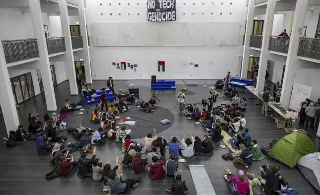 Pro-Palestinian students occupy a part of the SG building of the Swiss Federal Institute of Technology of Lausanne (EPFL) in Lausanne, Switzerland, Tuesday, May 7, 2024. Students held protests or set up encampments also in Finland, Denmark, Germany, Italy, Spain, France and Britain. (Jean-Christophe Bott/Keystone via AP)
