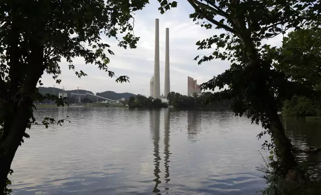 FILE - In this Aug. 7, 2019, photo, the Kingston Fossil Plant stands near a waterway in Kingston, Tenn. The nation’s largest public utility is moving ahead with a plan for a new natural gas plant in Tennessee despite warnings that its environmental review of the project doesn’t comply with federal law. The Environmental Protection Agency asked the Tennessee Valley Authority in a March 25, 2024 letter to redo several aspects of its environmental impact statement for converting the coal-burning Kingston Fossil Plant. (AP Photo/Mark Humphrey, File)