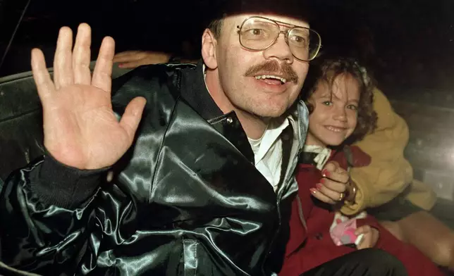 FILE - Terry Anderson, who was the longest held American hostage in Lebanon, grins with his 6-year-old daughter Sulome, Dec. 4, 1991, as they leave the U.S. Ambassador's residence in Damascus, Syria, following Anderson's release. Fellow former hostages, family, and coworkers celebrated the life of journalist and philanthropist Terry Anderson, Wednesday, May 8, 2024, as a man who helped others while struggling to heal himself. (AP Photo/Santiago Lyon, File)
