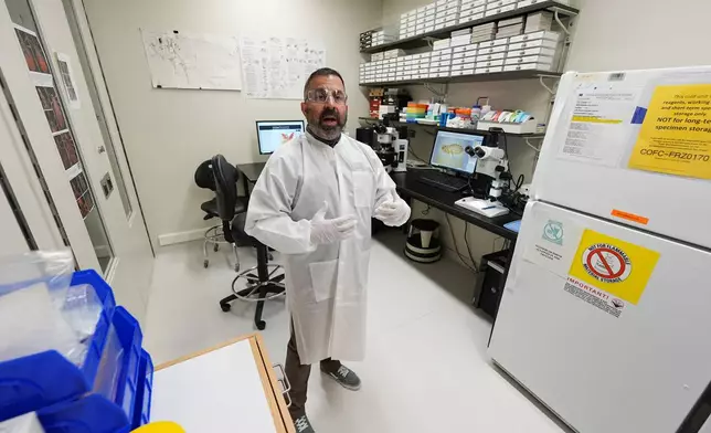 Researcher Erik Foster talks in his laboratory about ticks during a tour of the Center for Disease Control laboratory Thursday, April 4, 2024, in Fort Collins, Colo. (AP Photo/David Zalubowski)
