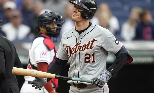 Detroit Tigers' Mark Canha (21) walks back to the dugout after striking out in the fifth inning of a baseball game against the Cleveland Guardians, Monday, May 6, 2024, in Cleveland. Guardians' catcher Bo Naylor, left, looks on. (AP Photo/Sue Ogrocki)