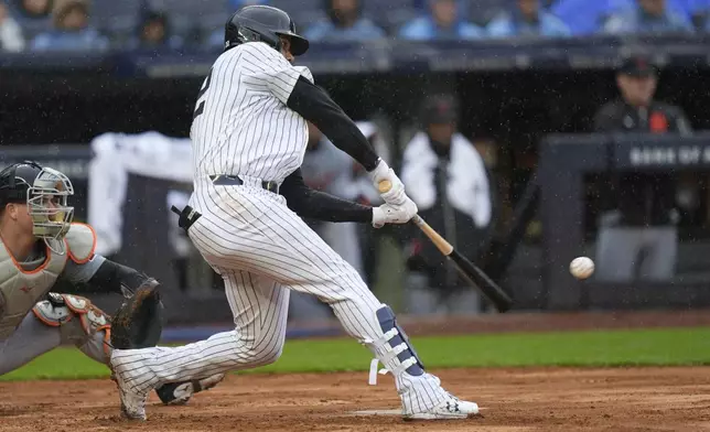 New York Yankees' Juan Soto hits a three-run double during the seventh inning of the baseball game against the Detroit Tigers at Yankee Stadium Sunday, May 5, 2024, in New York. (AP Photo/Seth Wenig)