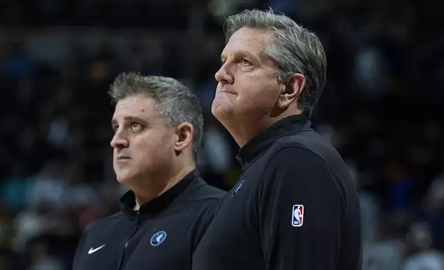 FILE - Minnesota Timberwolves head coach Chris Finch, right, and assistant coach Micah Nori watch in the first half of an NBA basketball game Friday, March 29, 2024, in Denver. The Timberwolves have two All-Stars in their lineup and the best defense in the NBA, but they likely wouldn't have secured the second-most wins in franchise history without a behind-the-scenes boost from a coaching staff led by Chris Finch that has forged a strong sense of camaraderie with each other and a clear level of trust with the players. (AP Photo/David Zalubowski, File)