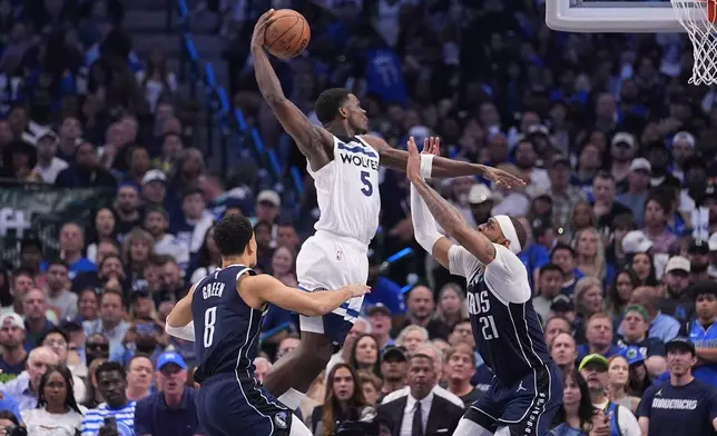 Minnesota Timberwolves guard Anthony Edwards (5) drives to the basket against Dallas Mavericks center Daniel Gafford (21) during the second half in Game 3 of the NBA basketball Western Conference finals, Sunday, May 26, 2024, in Dallas. (AP Photo/Julio Cortez)
