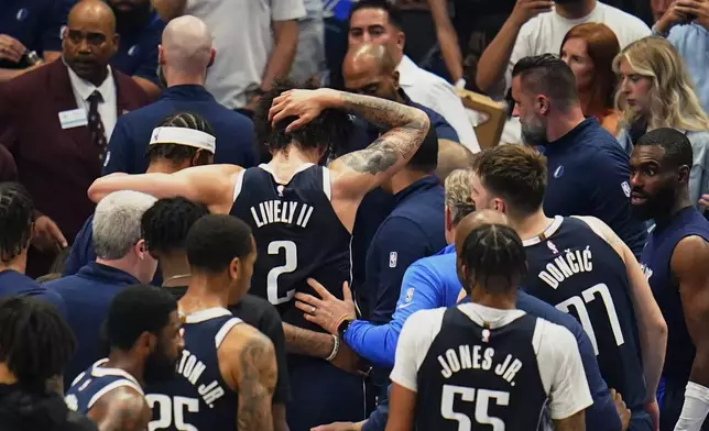 Dallas Mavericks center Dereck Lively II (2) is helped off the court after he received a head injury during the first half in Game 3 of the NBA basketball Western Conference finals against the Minnesota Timberwolves, Sunday, May 26, 2024, in Dallas. (AP Photo/Gareth Patterson)
