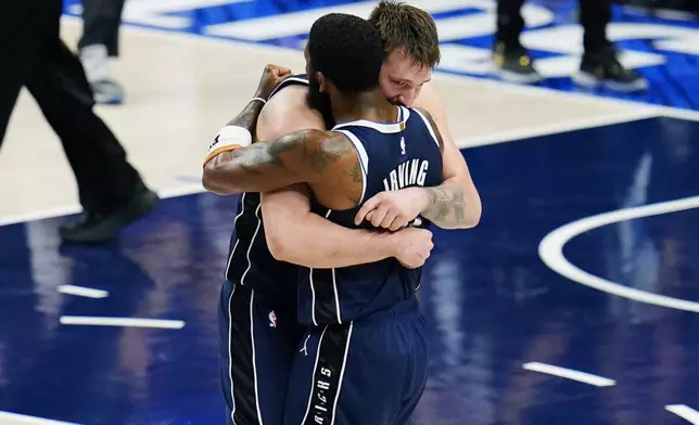 Dallas Mavericks guard Luka Doncic, left, and guard Kyrie Irving, right, embrace after their win over theMinnesota Timberwolves in Game 3 of the NBA basketball Western Conference finals, Sunday, May 26, 2024, in Dallas. (AP Photo/Gareth Patterson)
