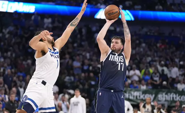 Dallas Mavericks guard Luka Doncic (77) shoots against Minnesota Timberwolves forward Kyle Anderson (1) during the second half in Game 3 of the NBA basketball Western Conference finals, Sunday, May 26, 2024, in Dallas. (AP Photo/Julio Cortez)