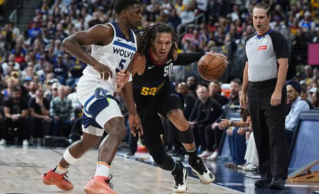 Denver Nuggets forward Aaron Gordon, second from left, drives past Minnesota Timberwolves guard Anthony Edwards, left, in the first half of Game 2 of an NBA basketball second-round playoff series Monday, May 6, 2024, in Denver. (AP Photo/David Zalubowski)