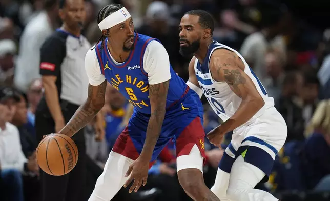 Denver Nuggets guard Kentavious Caldwell-Pope, left, looks to pass the ball as Minnesota Timberwolves guard Mike Conley, right, defends in the second half of Game 1 of an NBA basketball second-round playoff series Saturday, May 4, 2024, in Denver. (AP Photo/David Zalubowski)