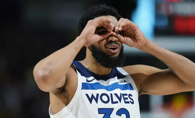 Minnesota Timberwolves center Karl-Anthony Towns gestures to the bench as a timeout is called in the first half of Game 1 of an NBA basketball second-round playoff series against the Denver Nuggets, Saturday, May 4, 2024, in Denver. (AP Photo/David Zalubowski)