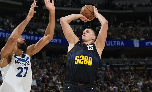 Denver Nuggets center Nikola Jokic shoots over Minnesota Timberwolves center Rudy Gobert during the first half of Game 5 of an NBA basketball second-round playoff series Tuesday, May 14, 2024, in Denver (AP Photo/David Zalubowski)