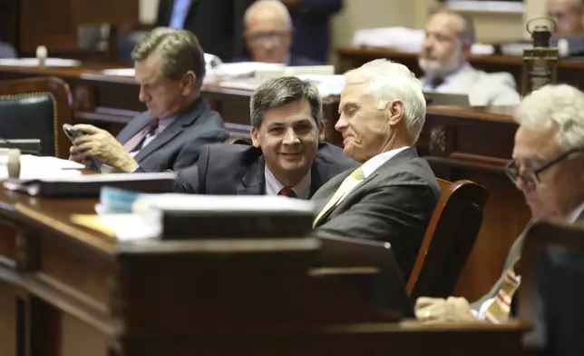 South Carolina Senate Majority Leader Shane Massey, R-Edgefield, left, and Sen. Chip Campsen, R-Isle of Palms, right, talk as the Senate debates a bill that would ban gender-affirming care for transgender minors on Wednesday, May 1, 2024, in Columbia, S.C. (AP Photo/Jeffrey Collins)