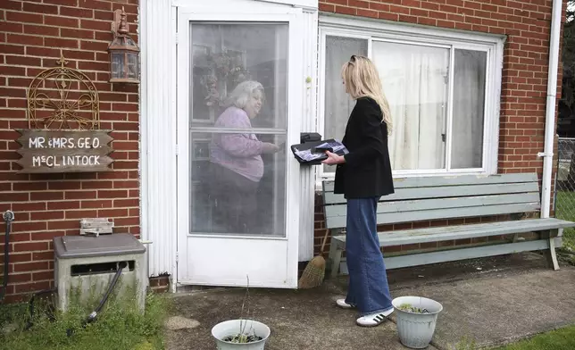Transgender Mayoral candidate Rosemary Ketchum (right) speaks with registered voter Michele McClintock (left) while canvassing on Friday, April 5, 2024, in Wheeling, W.Va. (AP Photo/Kathleen Batten)