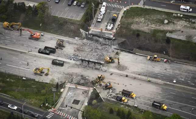 This aerial view shows demolition crews working to finish removing the Fairfield Avenue bridge over Interstate 95, Saturday, May 4, 2024 in Norwalk, Conn. Crews are expected to finish removing the bridge by Sunday morning, and road repairs will be made. The tanker truck burst into flames under the overpass after colliding with two other vehicles Thursday. The cause remains under investigation. (Kevin Coughlin / All Island Aerial via AP)