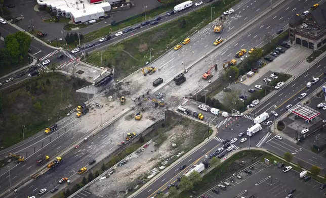 This aerial view looking south shows demolition crews working to finish removing the Fairfield Avenue bridge over Interstate 95, Saturday, May 4, 2024 in Norwalk, Conn. Crews are expected to finish removing the bridge by Sunday morning, and road repairs will be made. The tanker truck burst into flames under the overpass after colliding with two other vehicles Thursday. The cause remains under investigation. (Kevin Coughlin / All Island Aerial via AP)