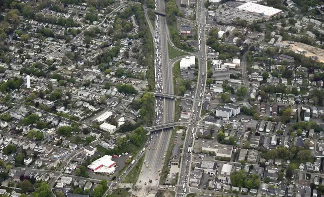 This aerial view looking south shows northbound traffic on Interstate 95 backed up as demolition crews work to finish removing the Fairfield Avenue bridge over Interstate 95, Saturday, May 4, 2024 in Norwalk, Conn. Crews are expected to finish removing the bridge by Sunday morning, and road repairs will be made. The tanker truck burst into flames under the overpass after colliding with two other vehicles Thursday. The cause remains under investigation. (Kevin Coughlin / All Island Aerial via AP)