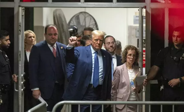 Former President Donald Trump, followed by his lawyer Susan Necheles, right, and advisor Boris Epshteyn, second from left, gestures as he returns to the courtroom following a break in his trial at Manhattan Criminal Court in New York, Thursday, May 9, 2024. (Victor J. Blue/The Washington Post via AP, Pool)