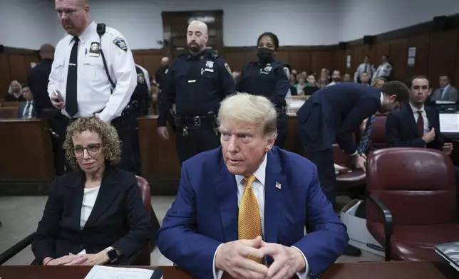 Former President Donald Trump, center, and attorney Susan Necheles, left, attend his trial at Manhattan criminal court on Tuesday, May 7, 2024, in New York. (Win McNamee/Pool Photo via AP)