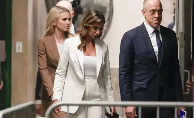 Former President Donald Trump's attorneys Alina Habba, center, and Emil Bove return to the courtroom following a break in his trial, Tuesday, May 7, 2024 in New York. (AP Photo/Mary Altaffer, Pool)
