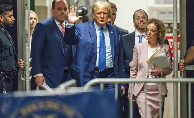 Former President Donald Trump, followed by his lawyer Susan Necheles, right, and advisor Boris Epshteyn, left, waves as he returns to the courtroom following a break in his trial at Manhattan Criminal Court in New York, Thursday, May 9, 2024. (Steven Hirsch/New York Post via AP, Pool)