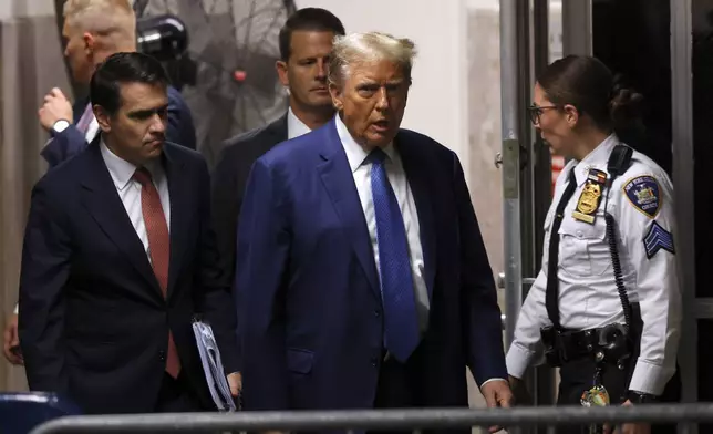 Former President Donald Trump walks with attorney Todd Blanche after a break during his trial at Manhattan Criminal Court on Monday, May 20, 2024 in New York. (Michael M. Santiago/Pool Photo via AP)