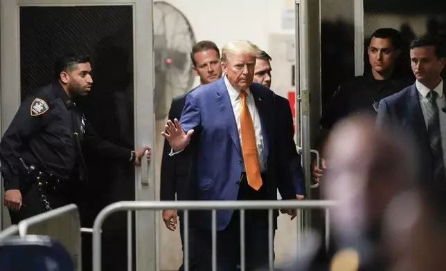 Former President Donald Trump gestures to reporters as he returns to the courtroom after a break in his trial, Tuesday, May 7, 2024, in New York. (AP Photo/Mary Altaffer, Pool)