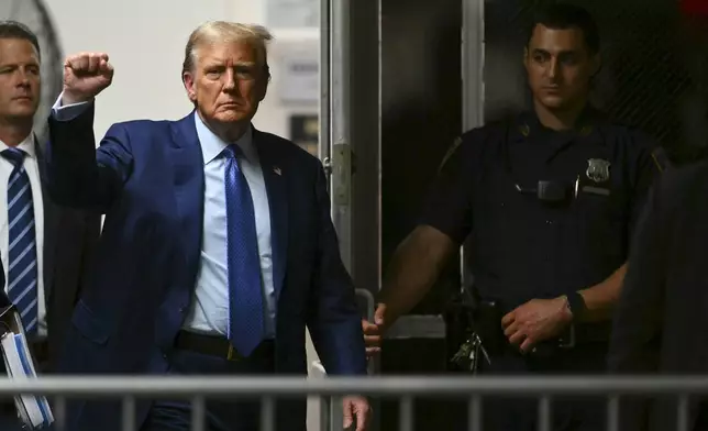 Former President Donald Trump gestures as he walks to the courtroom following a break in his trial at Manhattan criminal court Thursday, May 9, 2024, in New York. (Angela Weiss/Pool Photo via AP)