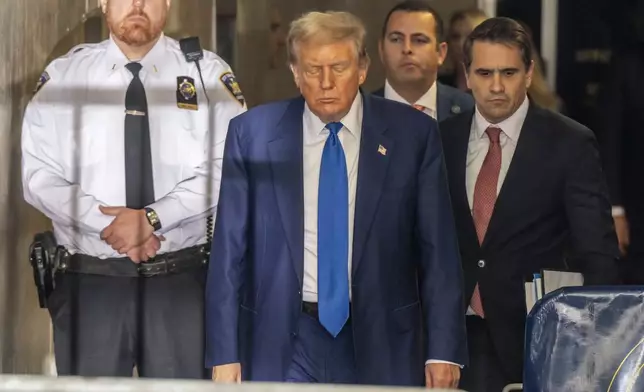 Former President Donald Trump walks outside the Manhattan Criminal Court room in his trial Friday, May 3, 2024, in New York. (Mark Peterson/Pool Photo via AP)