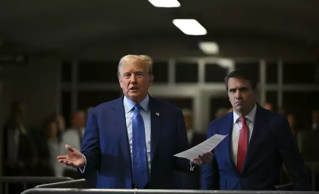 Former President Donald Trump, with lawyer Todd Blanche, speaks to reporters at Manhattan Criminal Court in New York, Thursday, May 9, 2024. (Angela Weiss/Pool Photo via AP)