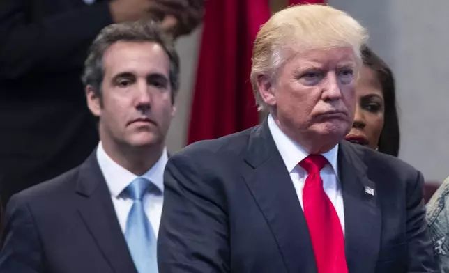 FILE- Republican presidential candidate Donald Trump, right, and attorney Michael Cohen, left, during a visit to the Pastors Leadership Conference at New Spirit Revival Center, Sept. 21, 2016, in Cleveland. Donald Trump’s fixer-turned-foe Michael Cohen returned to the witness stand Tuesday, testifying in detail how former president was linked to all aspects of a hush money scheme that prosecutors say was aimed at stifling stories that threatened his 2016 campaign. Trump is the first former U.S. president to go on trial. (AP Photo/ Evan Vucci, File)