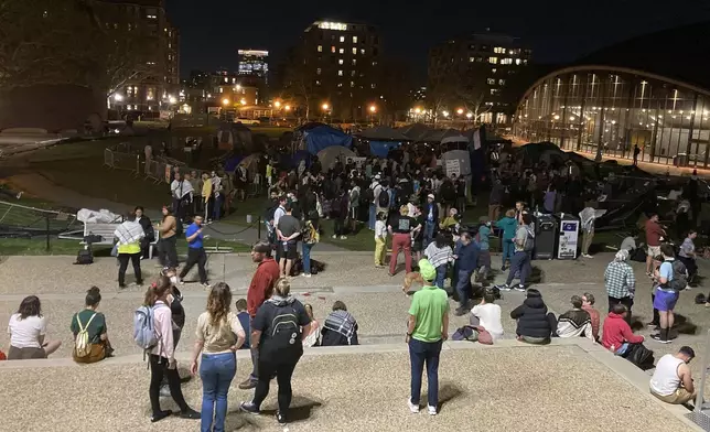 Protesters at the Massachusetts Institute of Technology gather around a tent encampment Monday evening, May 6, 2024, in Cambridge, Mass., after police and school officials failed to clear out the protest earlier in the day. (Steve LeBlanc)