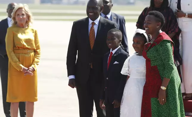 Kenya's President William Ruto, center, and first lady Rachel Ruto, right, pose for a picture upon their arrival at Andrews Air Force Base, Md., Wednesday, May 22, 2024, for a state visit to the United States as first lady Jill Biden, left, looks on. (AP Photo/Luis M. Alvarez)