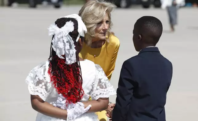 First lady Jill Biden, center, talks to flower presenters after Kenya's President William Ruto and first lady Rachel Ruto, arrived at Andrews Air Force Base, Md., Wednesday, May 22, 2024, for a state visit to the United States. (AP Photo/Luis M. Alvarez)