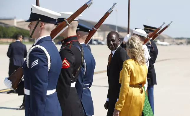 Kenya's President William Ruto, center, and first Lady Jill Biden, right, talk during an arrival ceremony at Andrews Air Force Base, Md., Wednesday, May 22, 2024, during President Ruto's state visit to the United States. (AP Photo/Luis M. Alvarez)