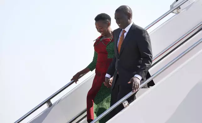 Kenya's President William Ruto, right, and first lady Rachel Ruto arrive at Andrews Air Force Base, Md., Wednesday, May 22, 2024, for a state visit to the United States. (AP Photo/Luis M. Alvarez)