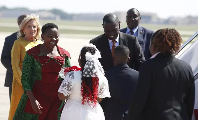 Kenya's President William Ruto, center, and first lady Rachel Ruto, second from left, arrive at Andrews Air Force Base, Md., Wednesday, May 22, 2024, for a state visit to the United States as first Lady Jill Biden, left, looks on. (AP Photo/Luis M. Alvarez)