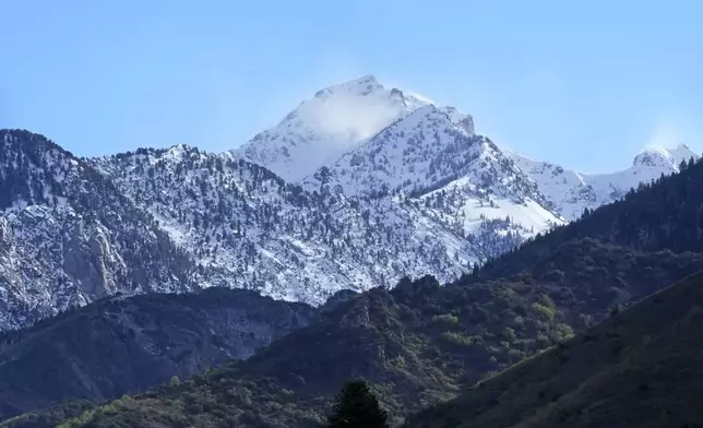 The Wasatch Mountains are seen from a recovery staging area Friday, May 10, 2024, in Sandy, Utah. Two backcountry skiers were killed and one was rescued after an avalanche Thursday, May 9, 2024, in the mountains outside of Salt Lake City. (AP Photo/Rick Bowmer)
